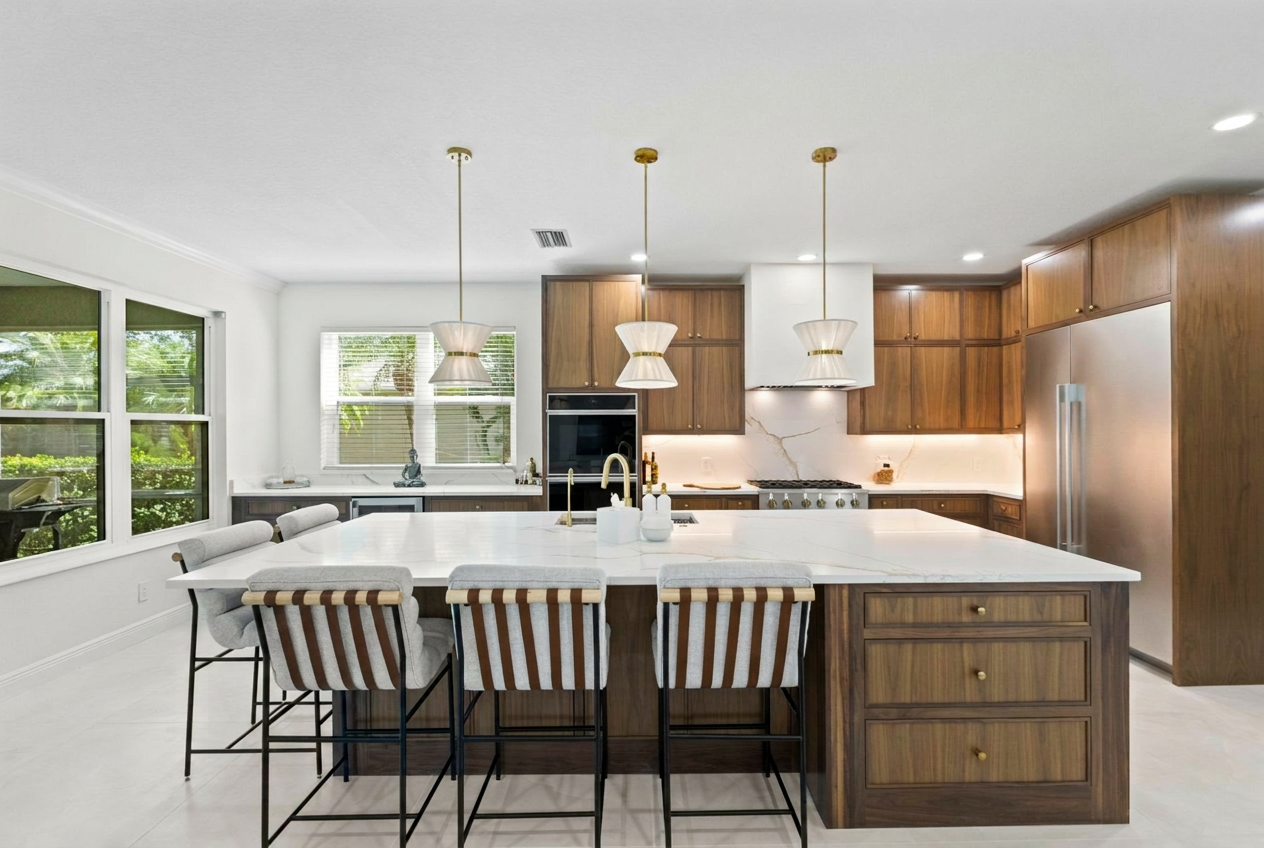 Bespoke sage green shaker kitchen with brass hardware and marble countertops by Brenton Gold, Sarasota