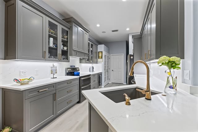 Dark, dramatic bespoke kitchen with custom cabinetry